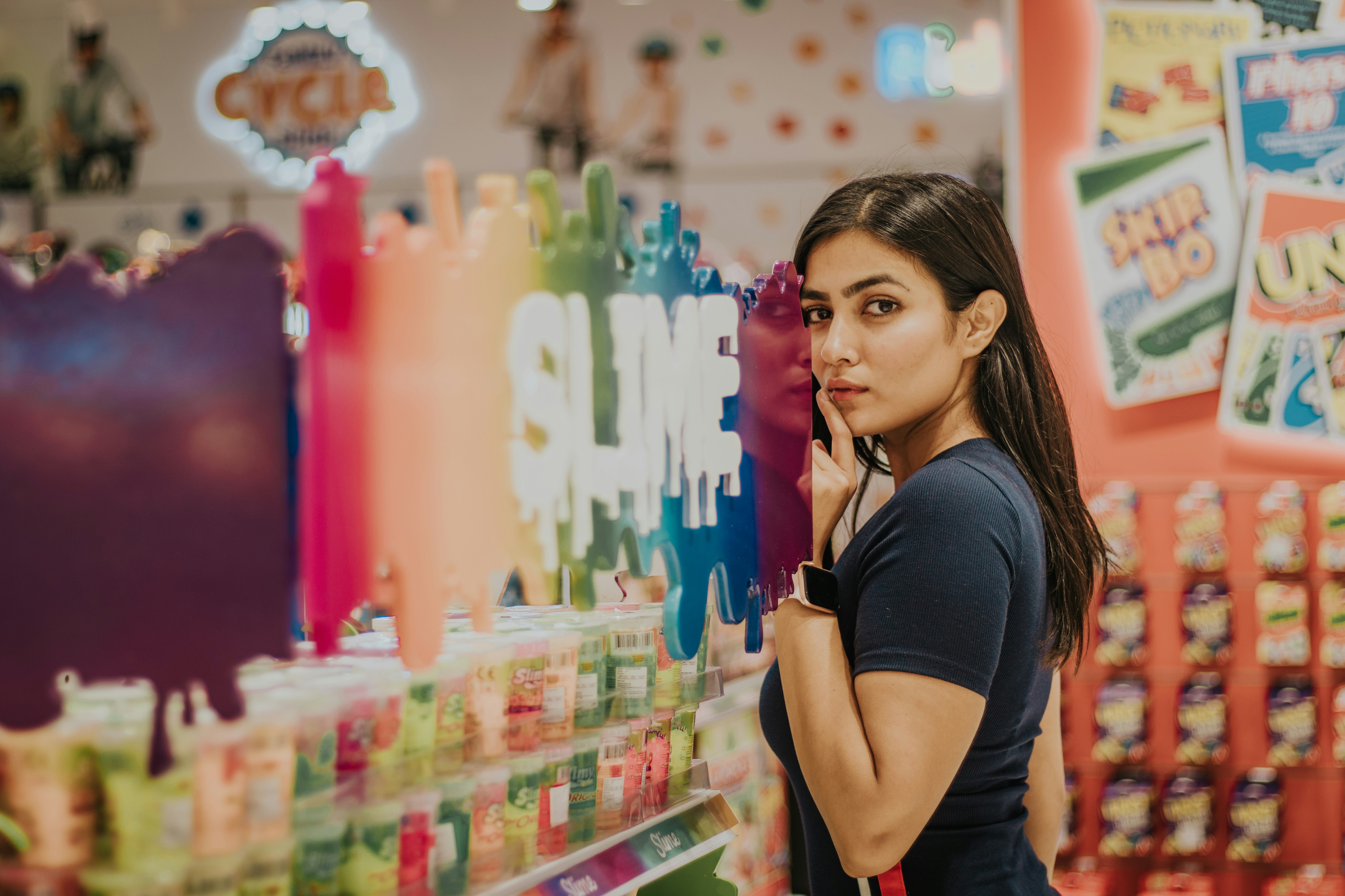 woman in black tank top standing beside assorted color plastic pack lot